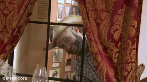Man In Straw Hat Looking Out Window GIF