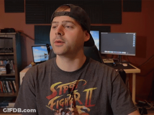 Man In Street Fighter Zero Shirt Holding Something GIF