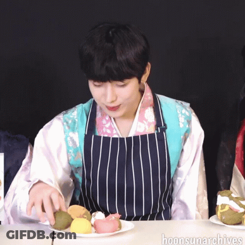 Man In Striped Apron Holding Plate Of Food GIF