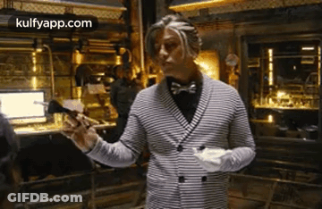 Man In Striped Jacket And Bow Tie Holding Paper GIF