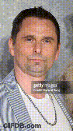 Man In Striped Jacket And Chain Featured In Newspaper Article GIF