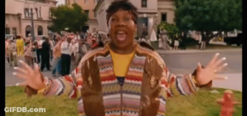 Man In Striped Jacket Standing In Crowd GIF