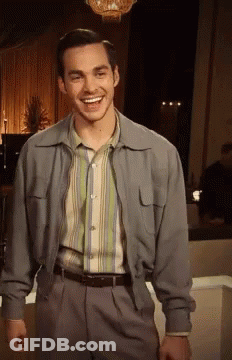 Man In Striped Shirt And Jacket Smiling GIF
