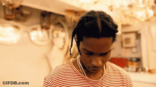 Man In Striped Shirt And Necklace Looking Down GIF