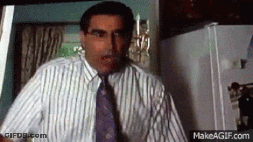 Man In Striped Shirt And Tie In Kitchen GIF