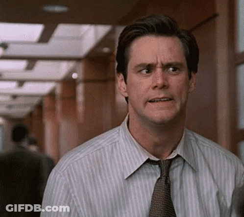 Man In Striped Shirt And Tie Looking At Camera GIF