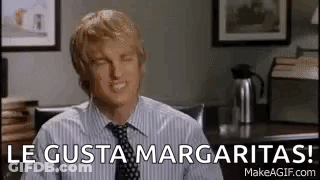 Man In Striped Shirt And Tie Smiling At Desk GIF