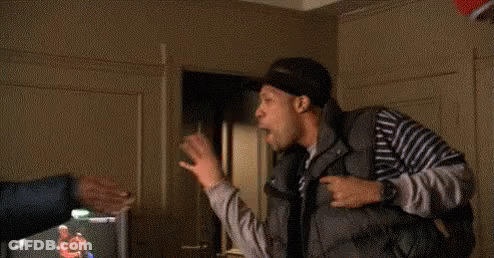 Man In Striped Shirt Beside Man In Living Room GIF