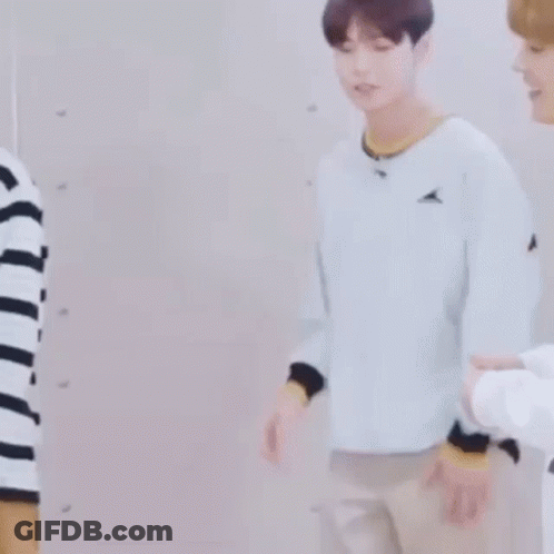 Man In Striped Shirt Beside Man In White Sweater GIF