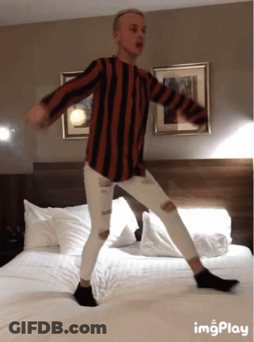 Man In Striped Shirt Dancing On Bed With ImgPlay GIF