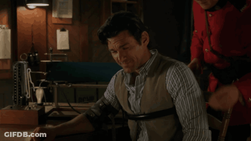 Man In Striped Shirt Examined By Red Jacket GIF