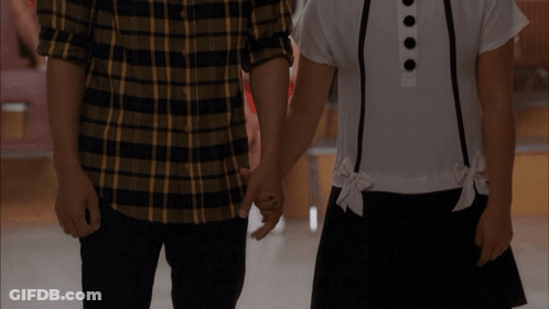 Man In Striped Shirt Examined By Red Jacket GIF