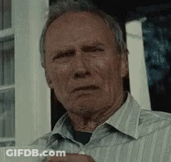 Man In Striped Shirt Holding Coffee Looking At Camera GIF