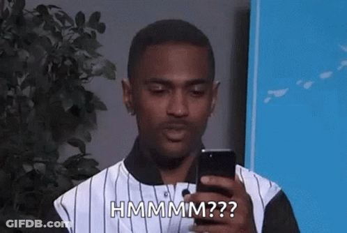 Man In Striped Shirt Holding Phone And Making Funny Face GIF