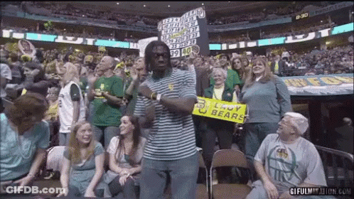 Man In Striped Shirt Holding Sign Saying Lady Bears GIF