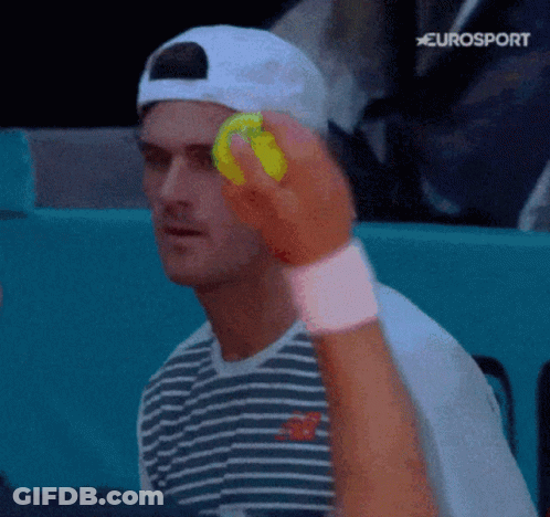 Man In Striped Shirt Holding Tennis Ball GIF