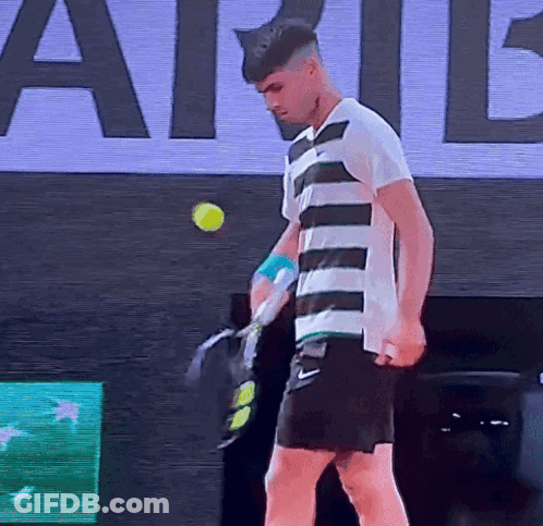 Man In Striped Shirt Holding Tennis Racquet GIF