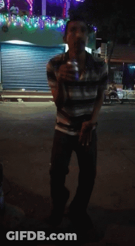 Man In Striped Shirt In Front Of Closed Store GIF