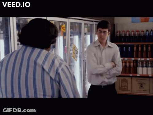 Man In Striped Shirt In Front Of Refrigerator Veed.io GIF