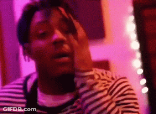 Man In Striped Shirt In Purple Room GIF