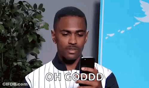 Man In Striped Shirt Looking At Cell Phone GIF