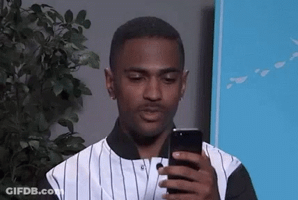 Man In Striped Shirt Looking At Phone GIF