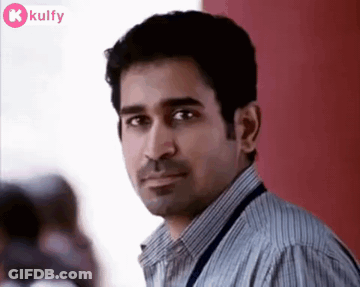 Man In Striped Shirt Looking Serious GIF
