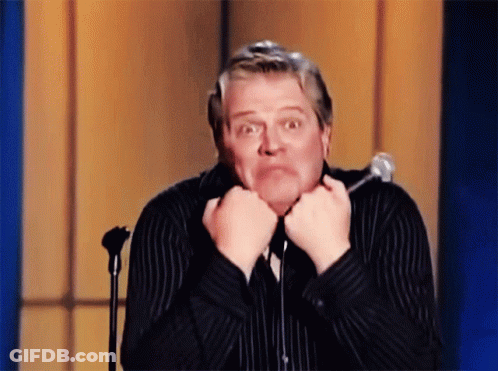 Man In Striped Shirt Making Funny Face At Microphone GIF