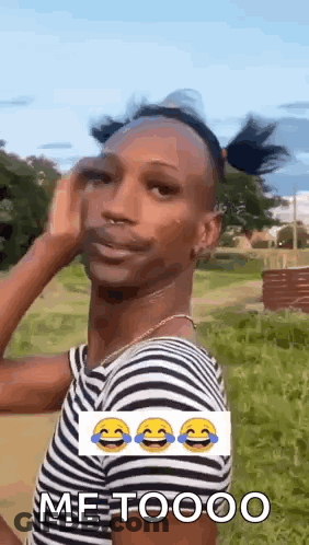 Man In Striped Shirt Making Funny Face In Grassy Field GIF