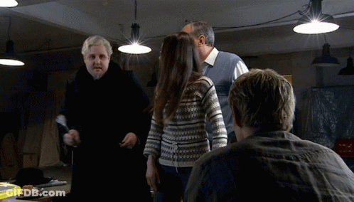 Man In Striped Shirt Making Funny Face Saying Here I Am GIF