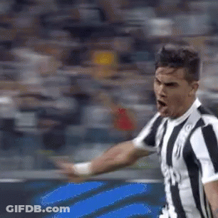 Man In Striped Shirt On Soccer Field Arm Outstretched GIF