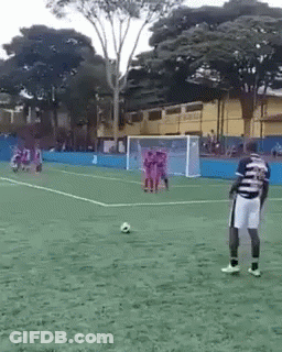Man In Striped Shirt On Soccer Field With Ball GIF