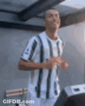 Man In Striped Shirt Running GIF