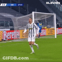 Man In Striped Shirt Running Towards Soccer Goal GIF