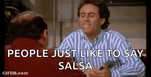 Man In Striped Shirt Sitting At Table With Man In Red Jacket GIF