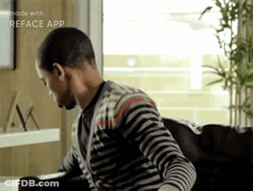 Man In Striped Shirt Sitting On Couch With Reface App GIF
