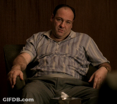 Man In Striped Shirt Sitting GIF