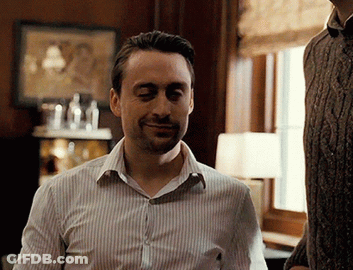 Man In Striped Shirt Smiling At Window GIF