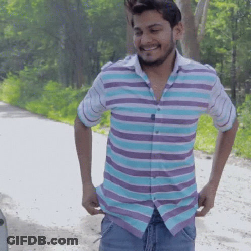 Man In Striped Shirt Smiling Holding Pockets GIF
