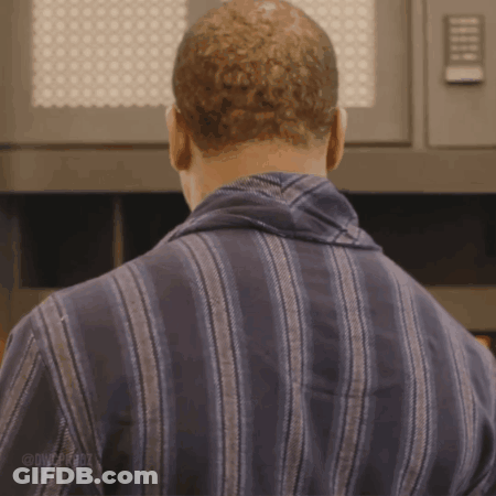 Man In Striped Shirt Standing In Front Of Microwave GIF
