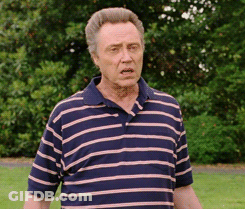 Man In Striped Shirt Standing In Park GIF