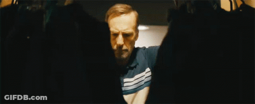 Man In Striped Shirt Standing With Arms Outstretched GIF