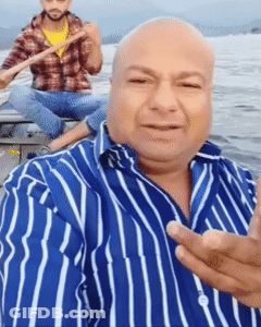 Man In Striped Shirt Taking Selfie With Another Man In Boat GIF