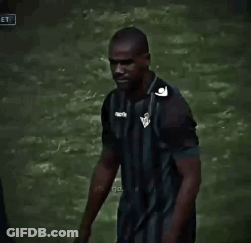 Man In Striped Shirt Talking To Another Man On Soccer Field GIF