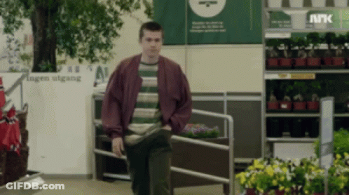 Man In Striped Shirt Walking By Hagen Utgang GIF