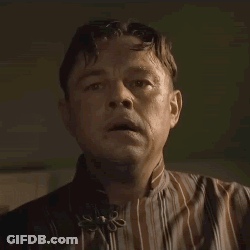 Man In Striped Shirt With Flower Collar GIF