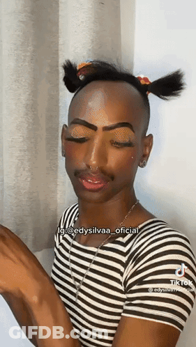 Man In Striped Shirt With Pigtail And Makeup GIF