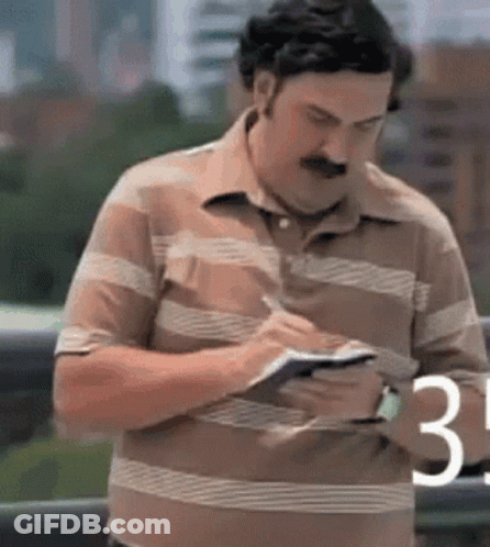 Man In Striped Shirt Writing GIF