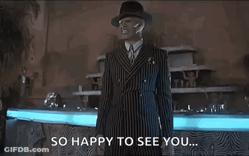 Man In Striped Suit And Hat By Fountain GIF
