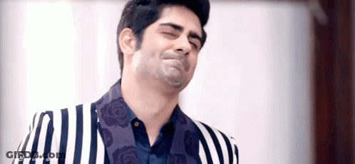 Man In Striped Suit Making Funny Face GIF